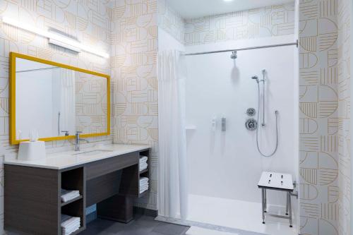 a bathroom with a sink and a shower with a mirror at Home2 Suites By Hilton East Haven New Haven in East Haven