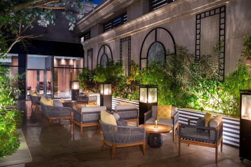 a rendering of a hotel patio with couches and tables at The Plaza Doha, LXR Hotels & Resorts in Doha