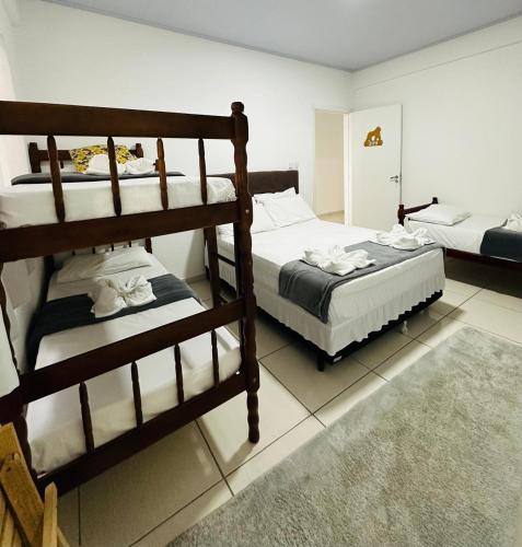 a bedroom with two bunk beds and a rug at Pousada Safari in Penha
