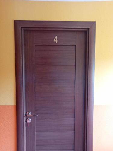 a wooden door with the number on it at Casa Jazmin Covasna in Covasna