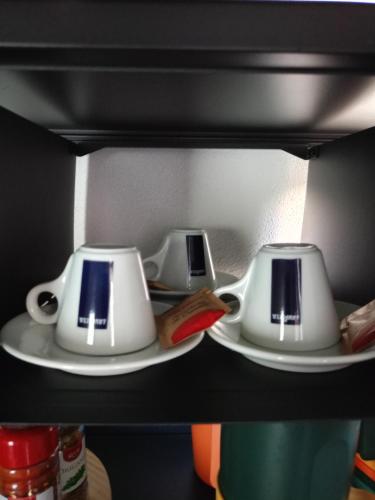 a shelf with two white toasters on plates at Jazz House in Solanas