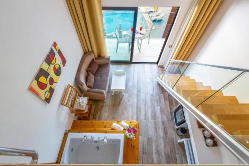 an overhead view of a living room with a staircase at Rhapsody Hotel & Spa Kalkan in Kalkan