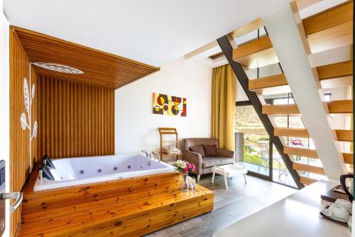a large bathroom with a tub and a staircase at Rhapsody Hotel & Spa Kalkan in Kalkan