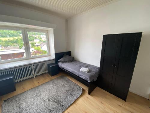 ein Schlafzimmer mit einem Bett und einem großen Fenster in der Unterkunft Kleever Apartment Bad Schwalbach in Bad Schwalbach
