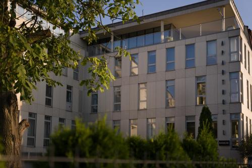 an office building with a lot of windows at Riverside Aparthotel Cracow in Kraków