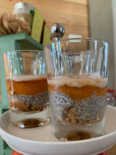 two glasses of food sitting on a plate at B&B EcoAntico casa in paglia in Maiolo