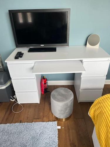 a white desk with a tv on top of it at Birkdale's Hidden Gem in Southport