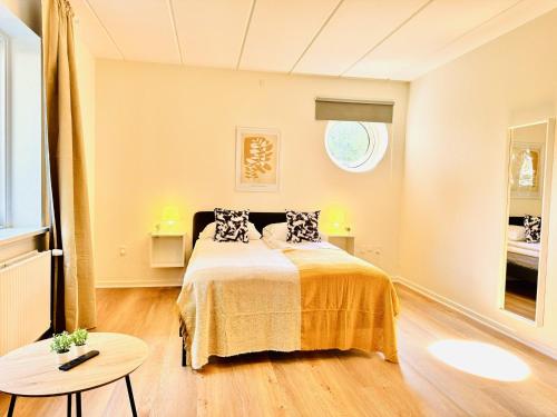 a bedroom with a bed with two pillows on it at aday - Bright Sunny Studio Apartment in Aalborg