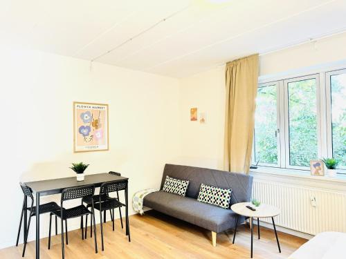 a living room with a couch and a table at aday - Bright Sunny Studio Apartment in Aalborg