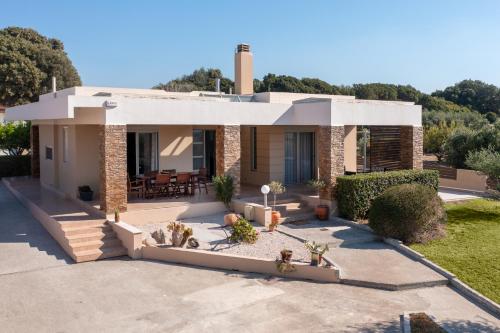 a house with a garden in front of it at Cielo Blu villa in Soroni