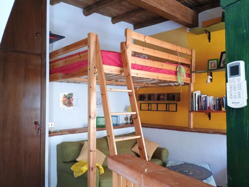 a bunk bed in a room with a couch at Pilgrims Corner in Campagnano di Roma