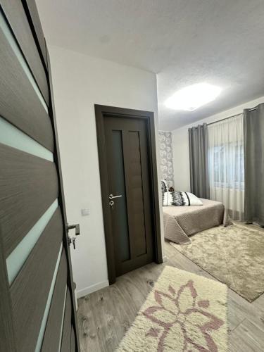a room with a door leading to a bedroom at Angela in Călimăneşti