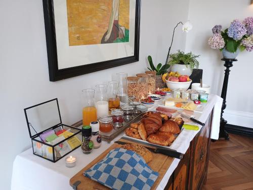 a breakfast buffet with bread and other foods on a table at Villa Paignon in Montbron