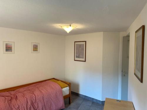 a small bedroom with a bed and a table at Davesco Court Apartment in Cadro