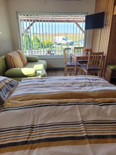a bedroom with a large bed and a table and chairs at Grubschützer Ferienhäuschen in Grubschütz