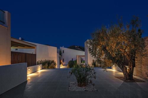 a courtyard of a house with a tree at night at Utopia Eco Retreat in Skiathos Town