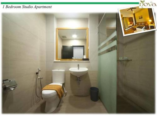 a bathroom with a sink and a toilet and a mirror at Cameron Nova Highlands Resorts II in Brinchang