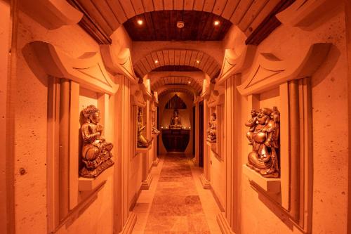 a hallway in a house with statues on the walls at Kapadokya Hill Hotel & Spa (12+) in Nevsehir