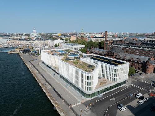 an aerial view of a large white building next to the water at Solo Sokos Hotel Pier 4 in Helsinki