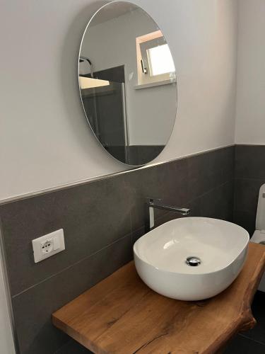 a bathroom with a white sink and a mirror at B&B La Casa in Collina in Trento