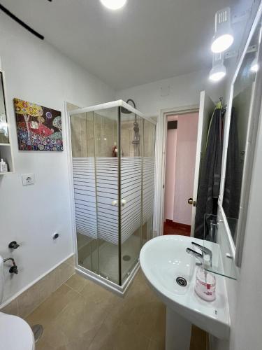 a bathroom with a shower and a sink at Luz, sol y arena in Rota