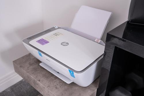 a white laptop computer sitting on top of a table at Premium Living Space in Rugby in Rugby