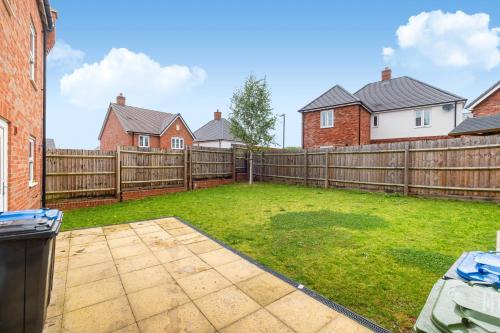 a backyard with a wooden fence and a yard at Premium Living Space in Rugby in Rugby