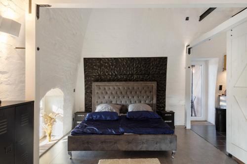 a bedroom with a large bed with a large headboard at Wohnen In Der Alten Brauerei in Neuhaldensleben