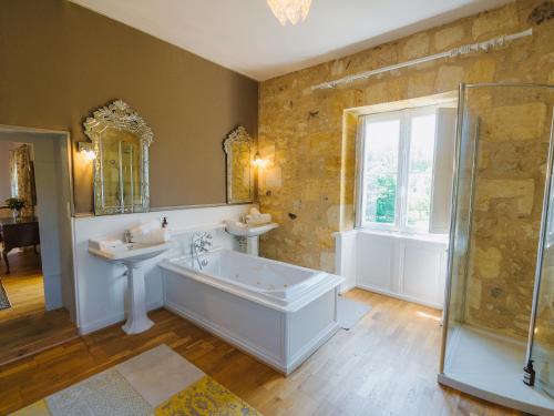 La salle de bains est pourvue d'une baignoire, de 2 lavabos et d'une douche. dans l'établissement Vivez la vie de Chateau aux portes de Bordeaux, à Saint-Sulpice-et-Cameyrac