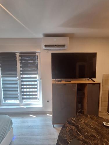 a living room with a large flat screen tv at Apartman CITY CENTER 5 in Prijedor