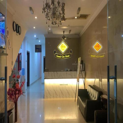 a lobby of a store with a couch and a chandelier at Grand City Hotel Kuantan in Kuantan