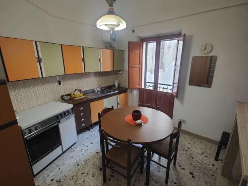 a kitchen with a table and chairs and a table and a table and a kitchen at casa vacanza pacentro in Pacentro