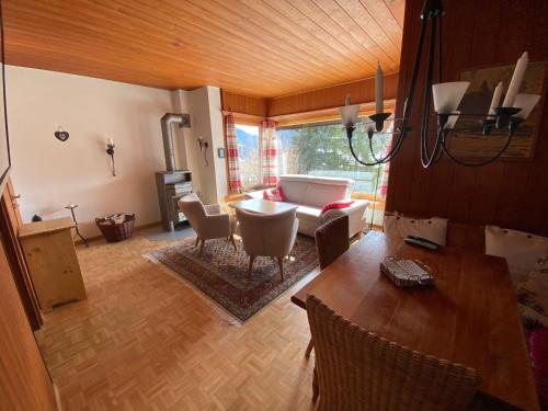a living room with a table and a couch at Tga Muntanela in Savognin