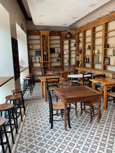 a dining room with wooden tables and chairs at Chambres de charme MAMIE ANGELE in Saint-Antonin-Noble-Val