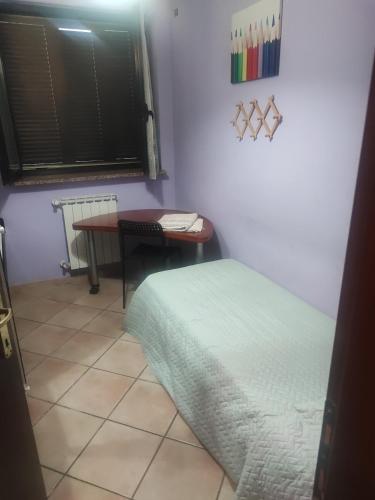 a room with a table and a bed and a desk at Regina in Acilia