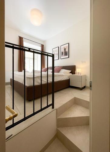 a bedroom with a bed and stairs leading to it at Petrin Tower Residence in Prague