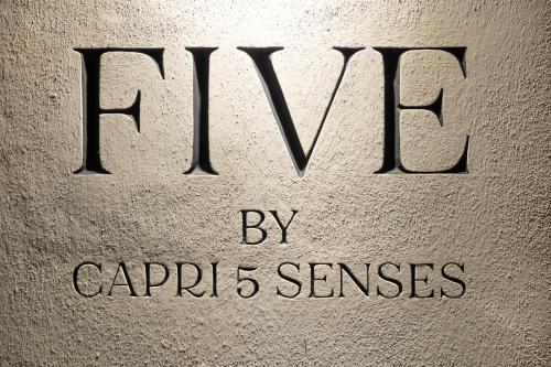 a close up of a sign with the word kvm on it at Five by Capri 5 Senses in Anacapri