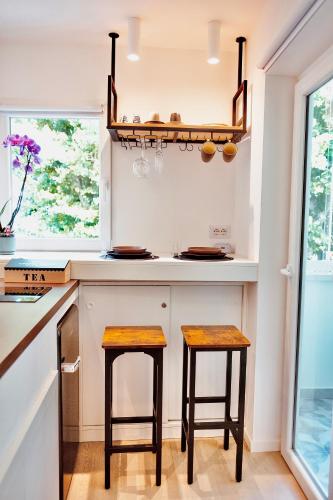 a kitchen with two stools at a counter at 18zero2 luxury rooms in Bari