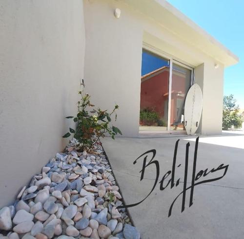 a house with a rock garden in front of a window at BeliHouse in Trafaria