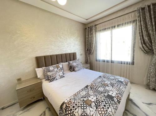 a bedroom with a large bed and a window at Yaluna Appart'hôtel & Restaurant in Tangier