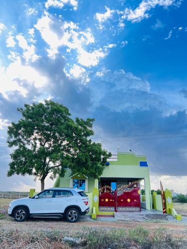a car parked in front of a store at Viky villa in Velānganni