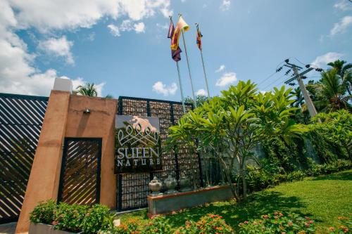 a sign at the entrance of a resort with plants at Sueen Nature Resort in Pelenda