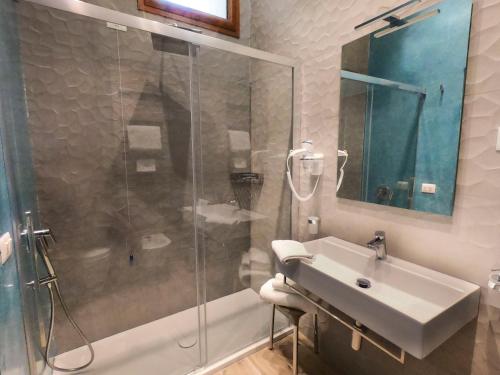 a bathroom with a glass shower and a sink at Relais Villa Montedonzelli in Naples