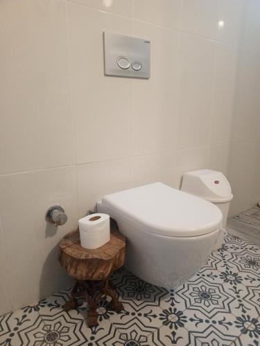a bathroom with a toilet and a table with toilet paper at Adrasan village house in Kumluca