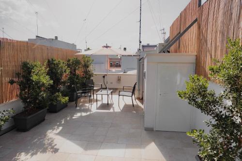 a patio with a table and chairs on a building at 18zero2 luxury rooms in Bari