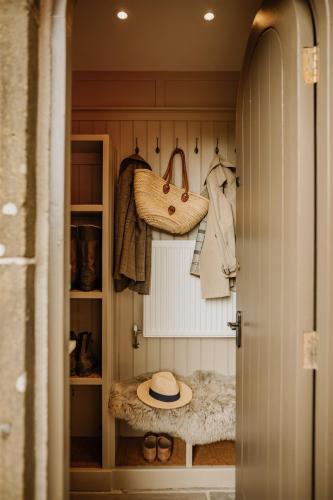 a walk in closet with a hat and purses at Lyme Tree Farm Cottages - Hotching Barn and Knockstone Cottage in Tideswell