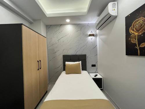 a small room with a bed and a cabinet at White Palace Haliç in Istanbul