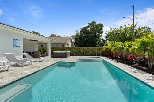 a swimming pool in the backyard of a home at Palm Luxe Residence in West Palm Beach