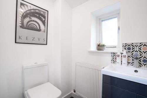 a bathroom with a toilet and a sink and a window at Charming 3-Bedroom Barn in Ambleside by LetMeStay in Ambleside