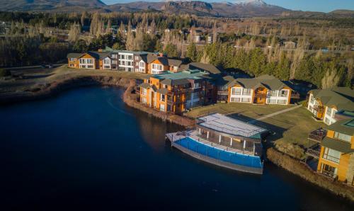an aerial view of a house with a boat in the water at Blue Aparts Dina Huapi Bariloche in Dina Huapi